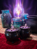 Transmute heavy energy with the Violet Flame Cauldron Candle. Hand-poured soy wax with raw Amethyst Elestial, Gold Obsidian, Smoke, Jasmine & Amaretto.