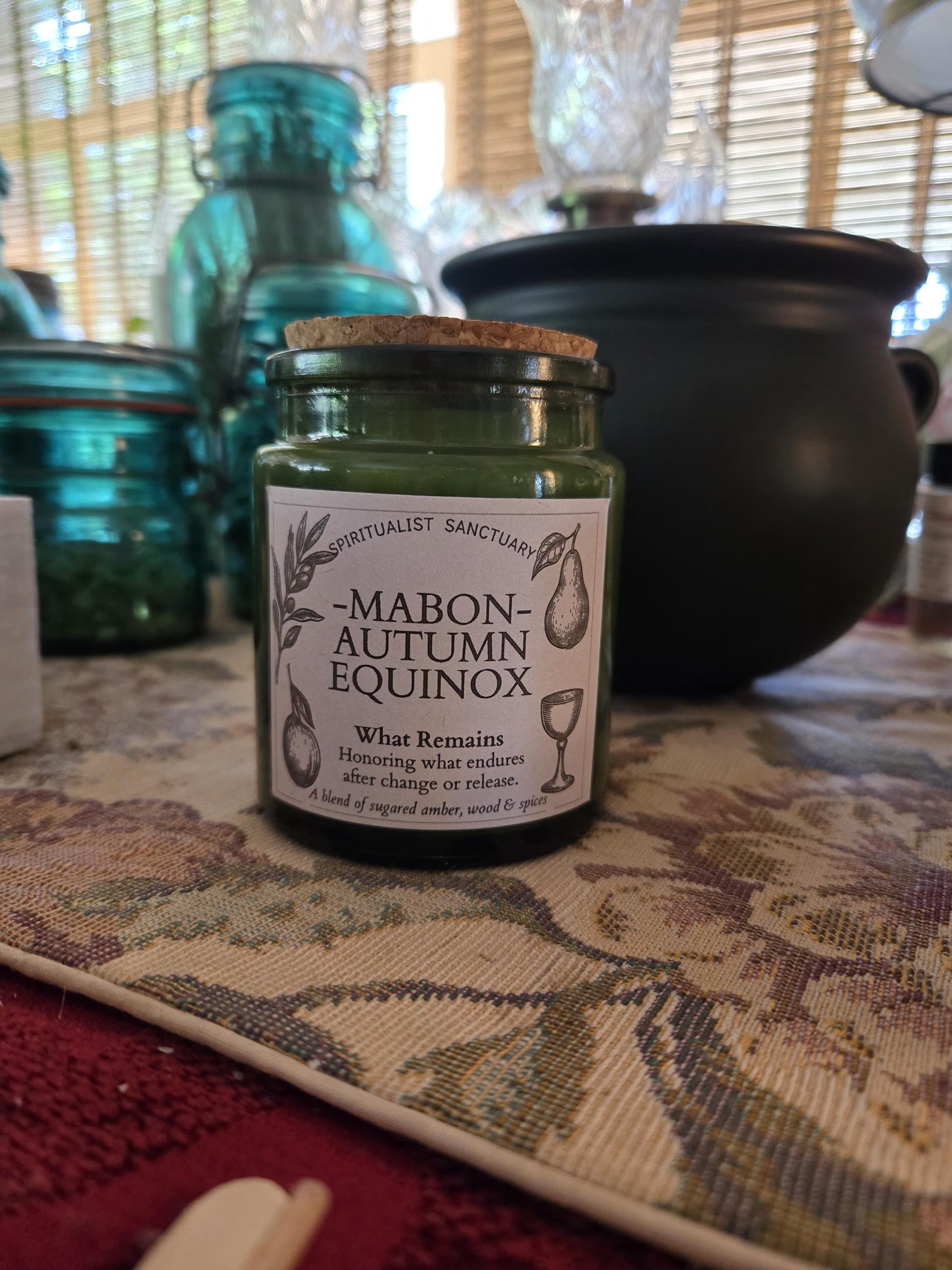 Celebrate the Autumn Equinox with our hand-poured Mabon soy candle. Infused with spiced apple, warm clove, and rich amber resins, this dark botanical wax candle brings cozy fall vibes and grounding harvest energy to your sacred space. Hand-crafted with eco-friendly soy wax and topped with real dried botanicals. Perfect for cozy fall decor, Mabon altars, and autumn ritual practice.